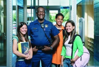 Security officer posing with teenagers